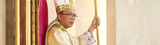 Mons. Herman Abcede RCJ, seated on the cathedra assuming the role as the 5th bishop of the Diocese of Daet